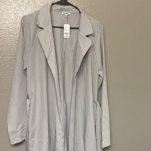 A grey trench coat never worn